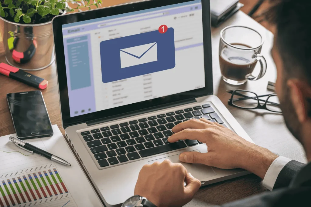 Overhead view of a laptop displaying a phishing alert email icon
