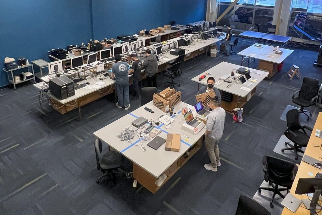 A top-down view of the PC Professional engineers working in the engineering room.