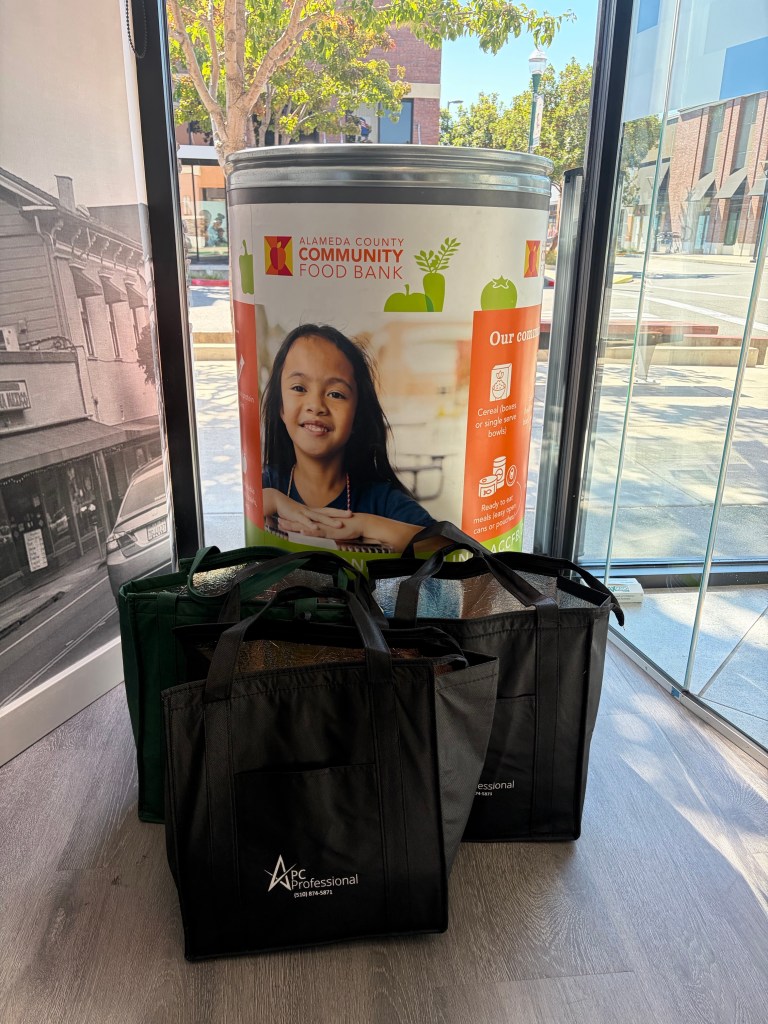 3 PC Professional bags filled with food in front of the Alameda County Community Food Bank drop off bin