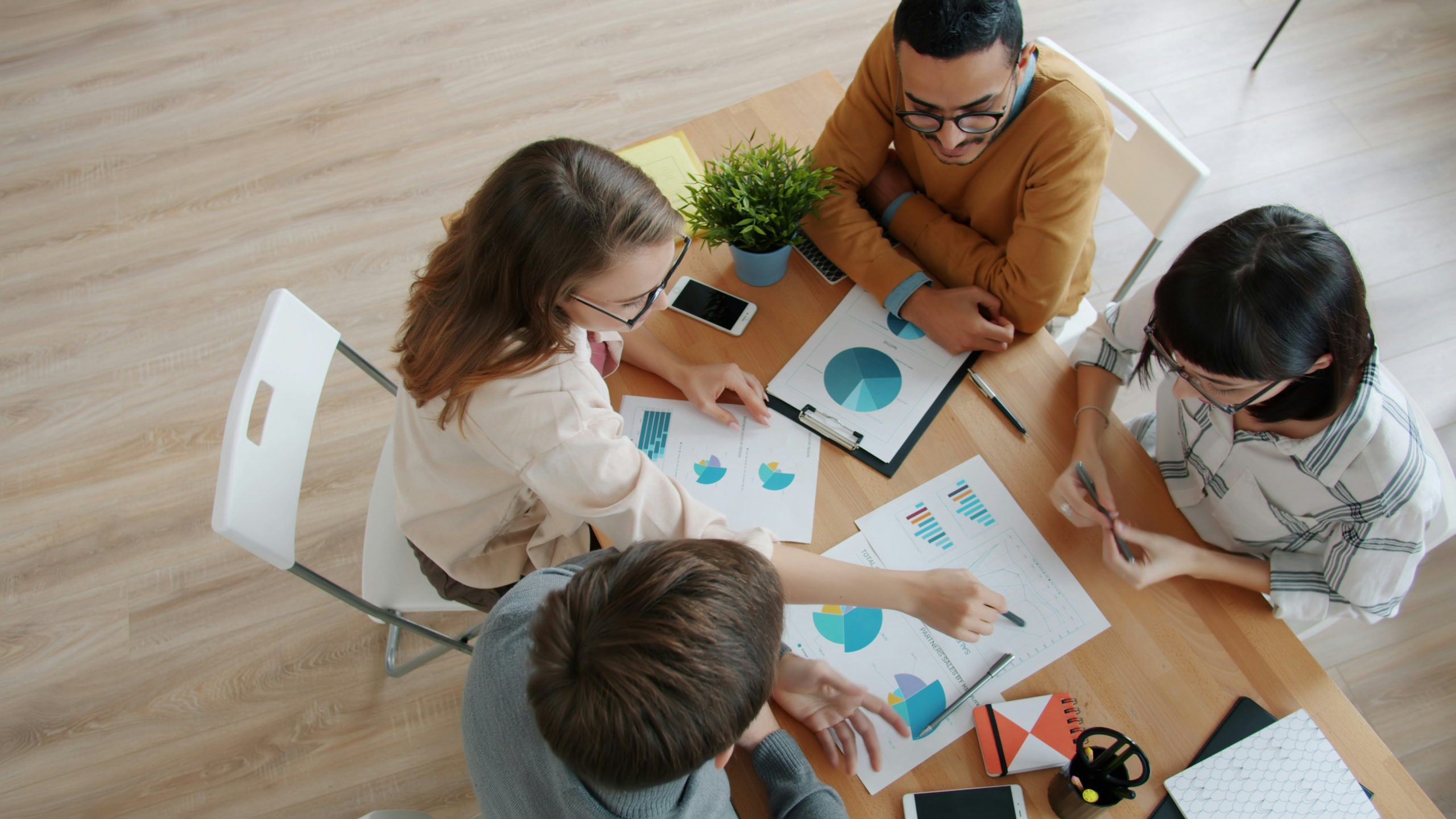 A nonprofit team sitting around a table weighing different IT support options.