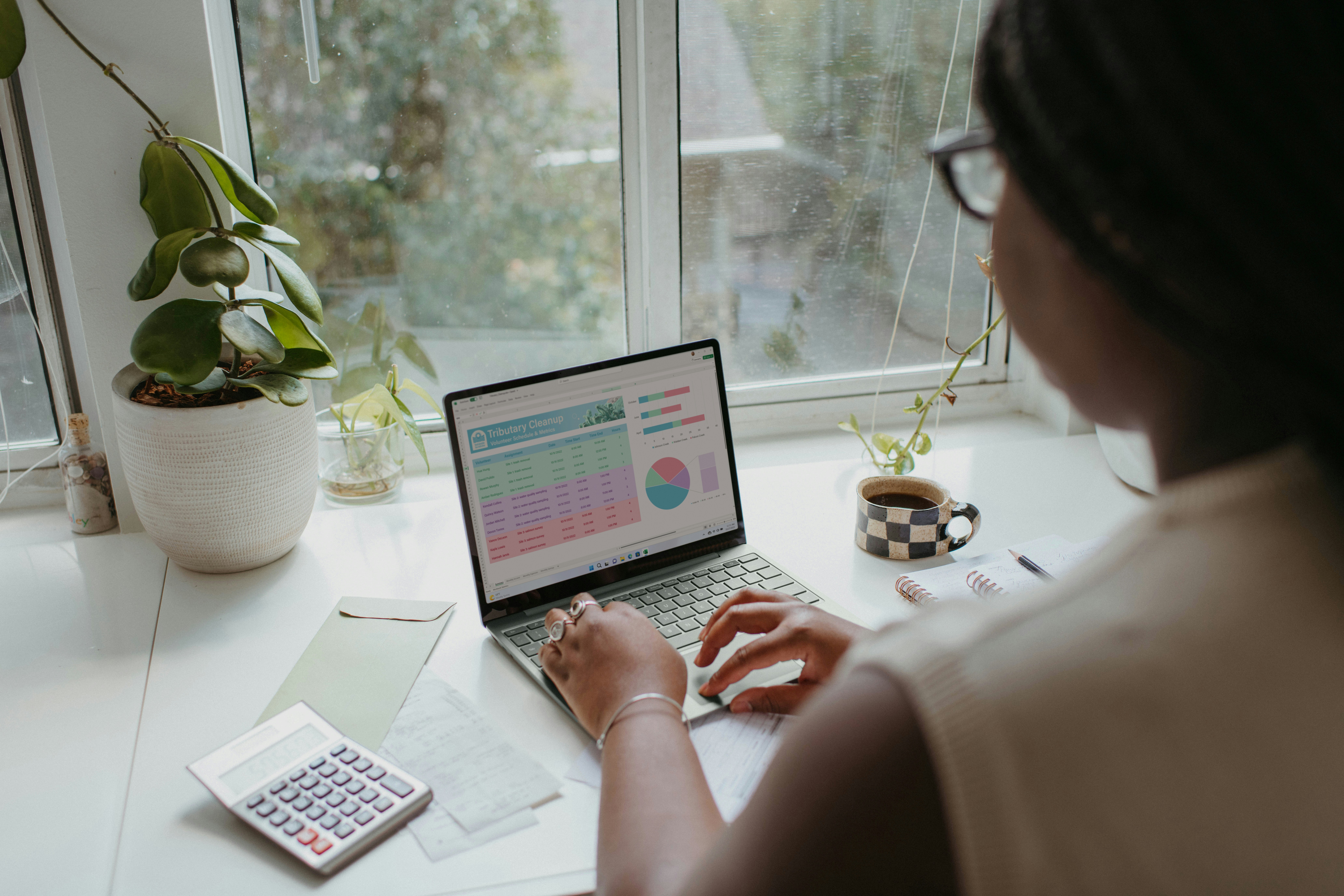 A woman looking at budget information on her laptop.